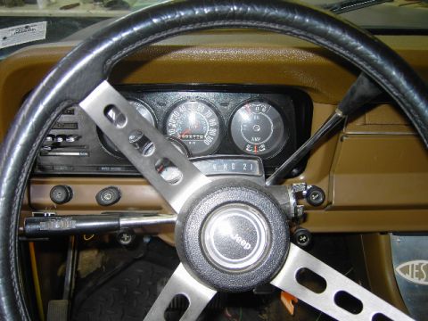 1977 Jeep Wagoneer - Interior view of a 1977 Jeep Wagoneer dashboard, showing the steering wheel, gauges, and gear selector.