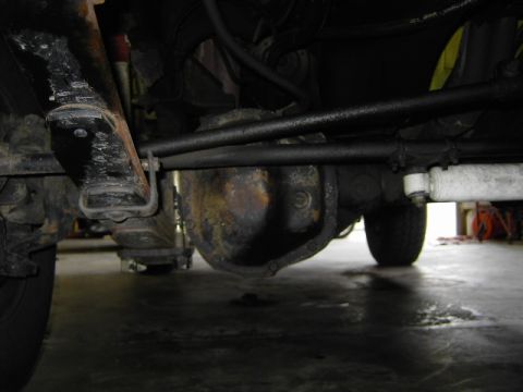 1977 Jeep Wagoneer - Close-up view of the vehicle's undercarriage, showing the front axle and differential assembly.