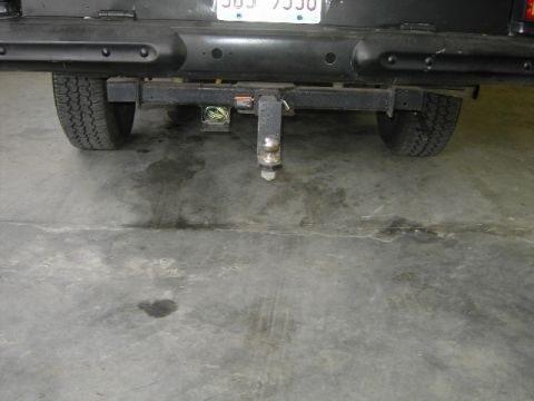 1977 Jeep Wagoneer - Rear view of a 1977 Jeep Wagoneer, showing the bumper, trailer hitch, and license plate.
