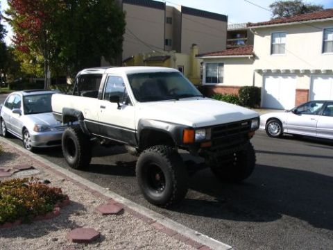 1985 Toyota 4Runner - Lifted 1985 Toyota 4Runner parked on a residential street with other vehicles nearby.