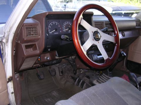 1985 Toyota 4Runner - The interior of a 1985 Toyota 4Runner shows its dashboard, steering wheel, and manual shifter.