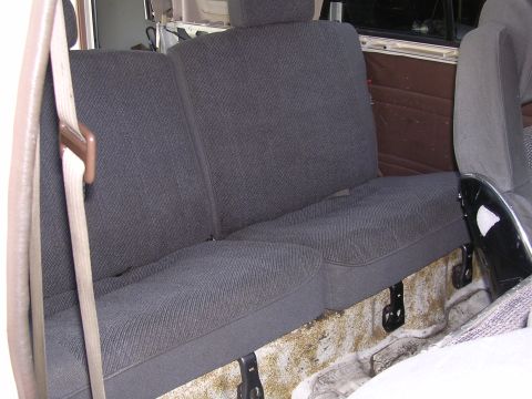 1985 Toyota 4Runner - Interior view of a vehicle's rear bench seat with dark grey fabric upholstery.