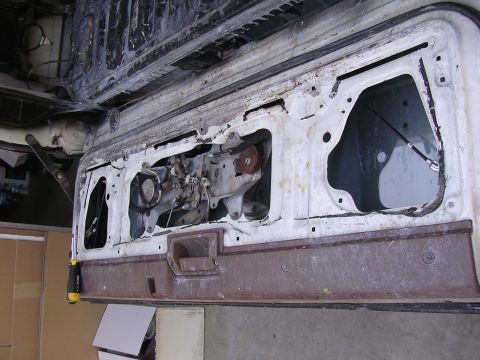 1985 Toyota 4Runner - Close-up view of a vehicle's tailgate interior, showing the mechanical components and wear.