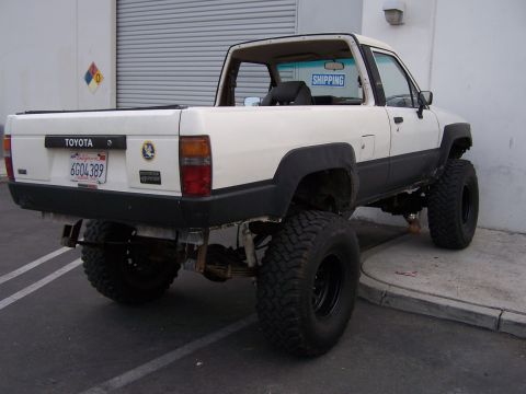 1985 Toyota 4Runner - This lifted Toyota pickup truck appears to be a 1985 model based on its body style.