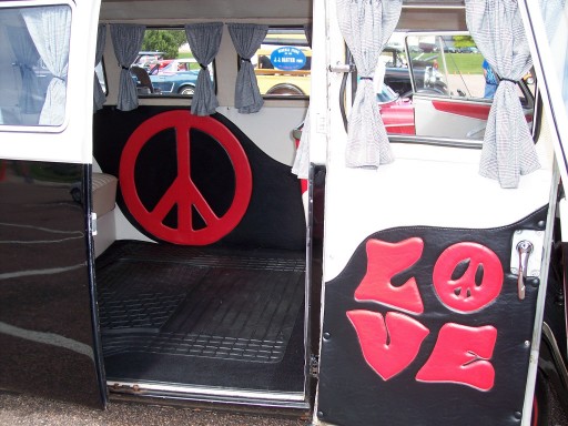 Van side doors open showing red peace sign and LOVE lettering on black interior panels