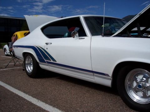 1972 Ford Ranchero - A white coupe with blue racing stripes is parked outdoors, with its hood open.