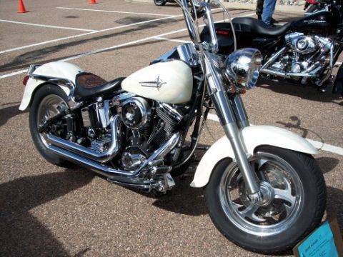 1972 Ford Ranchero - A white motorcycle is parked on asphalt, with another black motorcycle visible behind it.
