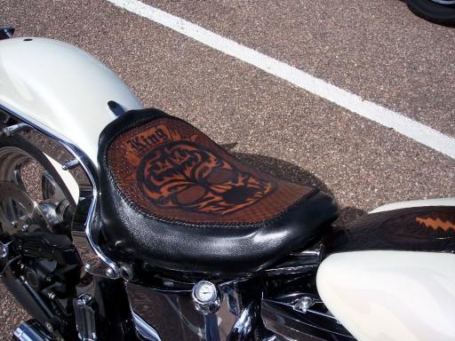 Custom solo motorcycle seat with tooled brown leather insert reading King