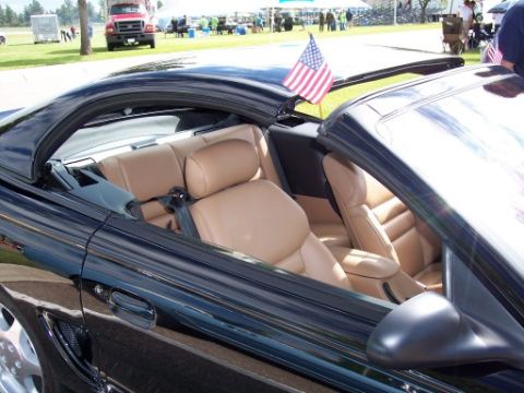 1972 Ford Ranchero - Interior view of a black convertible with tan leather seats, an American flag on the roof.