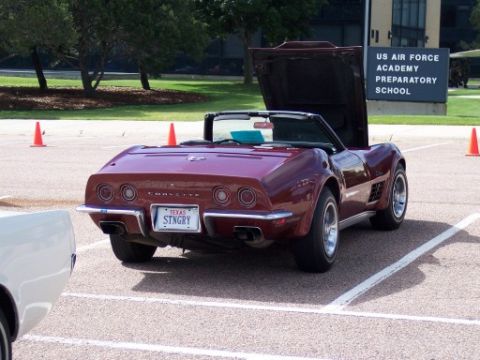 1972 Ford Ranchero - A maroon Chevrolet Corvette Stingray convertible is parked with its hood open, showing a Texas license plate.