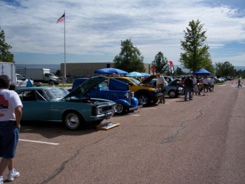 1972 Ford Ranchero - A teal coupe, possibly a 1972 Ford Ranchero, is displayed with its hood open at an outdoor event.