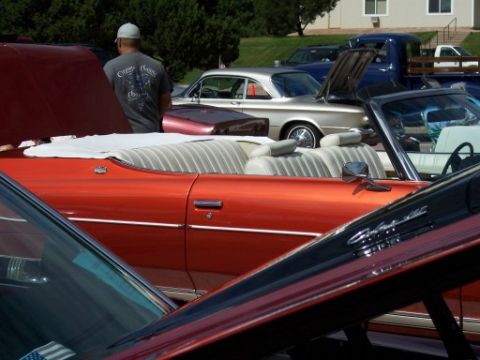 1972 Ford Ranchero - A gathering of vintage automobiles is displayed outdoors, with multiple vehicles visible in the frame.