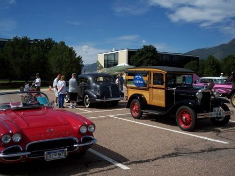 1972 Ford Ranchero - A 1930s Ford woody wagon is displayed alongside other vintage vehicles.