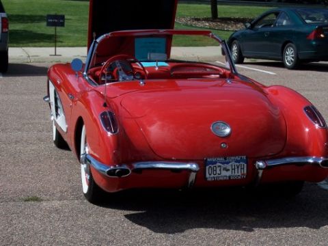 1972 Ford Ranchero - A classic red convertible sports car is parked with its hood open, showing off its interior.