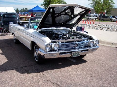 1972 Ford Ranchero - A classic white convertible is displayed with its hood open, revealing the engine compartment.