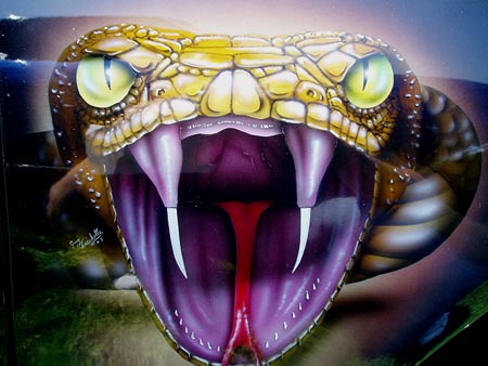 1978 Ford Mustang II - A close-up airbrushed mural depicts a snake's head with its mouth open, revealing fangs and a red tongue.