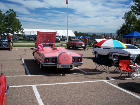 1972 Ford Ranchero - A pink convertible is displayed with its hood open, a spare tire mounted on the rear.