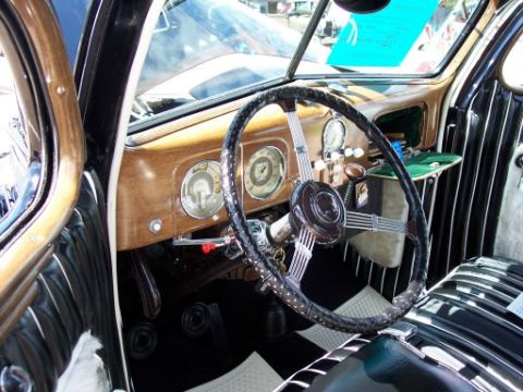 1972 Ford Ranchero - Interior view of a vintage car with woodgrain dashboard and striped seats.