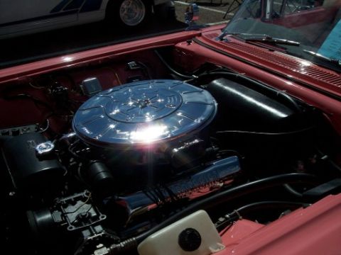 1972 Ford Ranchero - The engine bay of a classic car, a prominent chrome air filter housing and pink exterior paint.