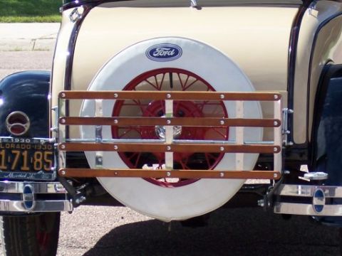 1972 Ford Ranchero - The rear of a vintage car shows a spare tire and a wooden luggage rack.