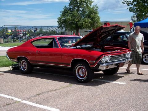 1972 Ford Ranchero - A red 1969 Chevrolet Chevelle coupe is displayed with its hood open, parked outdoors.