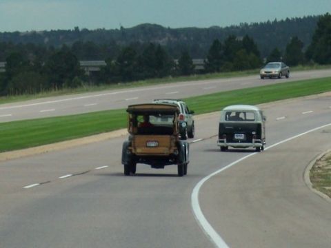 1972 Ford Ranchero - Multiple vehicles travel on a highway with a vintage car in the foreground.