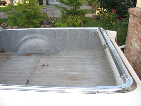 1966 Ford Ranchero - The bed of a 1966 Ford Ranchero shows its interior with a visible wheel well and tie-down loop.