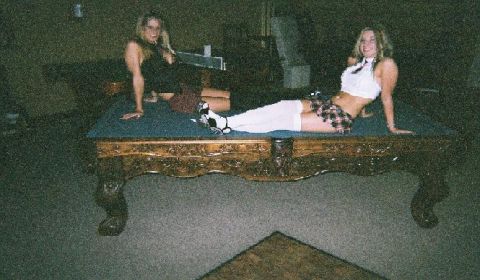 1991 Ford Bronco - Two women pose on a pool table in a dimly lit room.