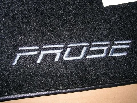 1996 Ford Probe - A black floor mat with the word PROBE embroidered in white lettering is shown up close.