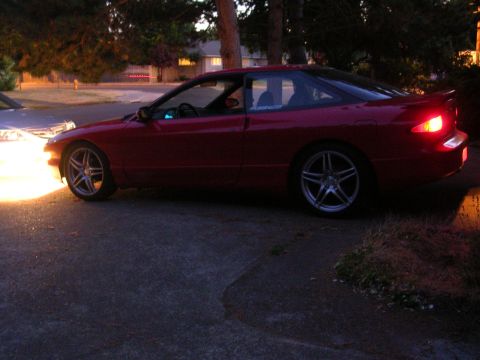 1996 Ford Probe - A red 1996 Ford Probe coupe is parked on a driveway at dusk.