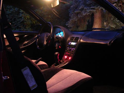 1996 Ford Probe - The interior of a 1996 Ford Probe is visible at night, illuminated by interior lights and the dashboard display.