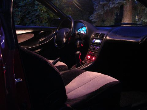1996 Ford Probe - Interior view of a car at night, illuminated by dashboard lights and aftermarket accent lighting.