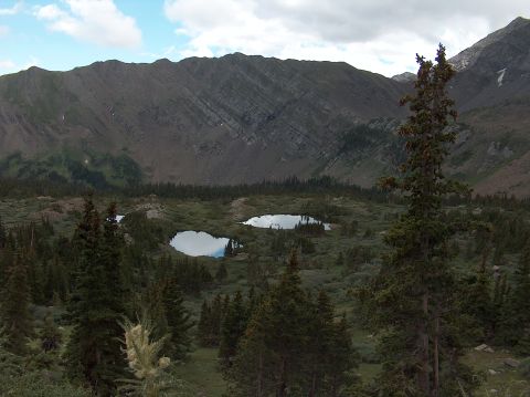1978 Ford Bronco - A scenic view of a mountain valley with two reflective lakes among evergreen trees.