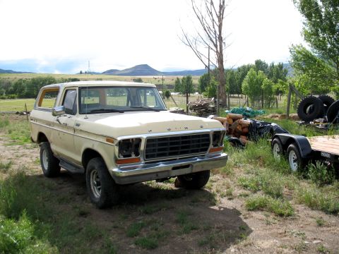 1979 Ford Bronco - This 1979 Ford Bronco, noted as a parts truck in the registry, is seen parked in a rural setting with its headlights missing.