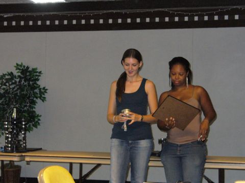1991 Ford Probe - Two women are presented with awards at an indoor event, with a decorative plant visible in the background.