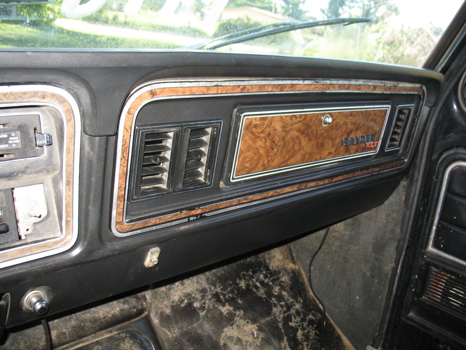 1979 Ford Bronco interior dashboard with wood grain trim and XLT badge