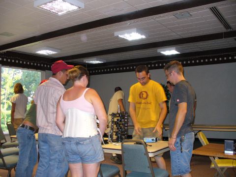 1991 Ford Probe - A group of people are gathered around a table, examining what appear to be mechanical components.