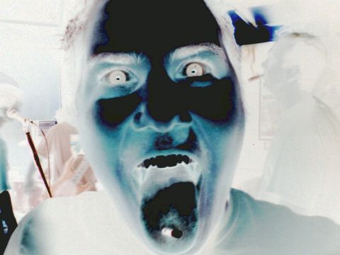 2001 Ford Crown Victoria - This image shows a person with an exaggerated expression, rendered in inverted colors.