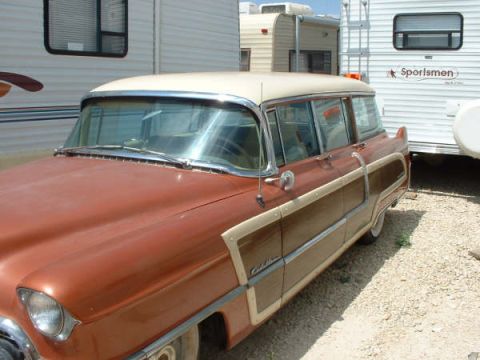 1972 Ford Ranchero - This classic station wagon, likely a Cadillac, is parked outdoors with RVs in the background.