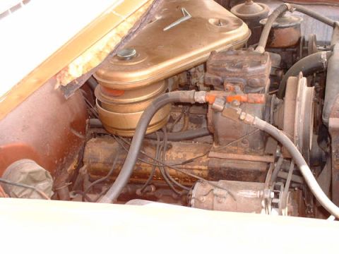 1972 Ford Ranchero - Close-up view of a V8 engine in an older vehicle, showing various components and hoses.