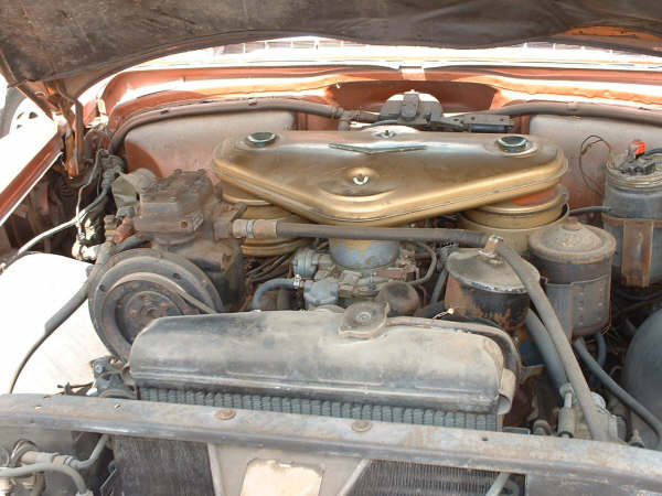 Engine bay with gold air cleaner housing and various hoses and components