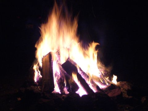 1991 Ford Probe - A roaring bonfire illuminates the night sky with vibrant flames and glowing embers.