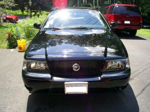 2003 Mercury Marauder - Front view of a black 2003 Mercury Marauder parked outside, with a red SUV in the background.