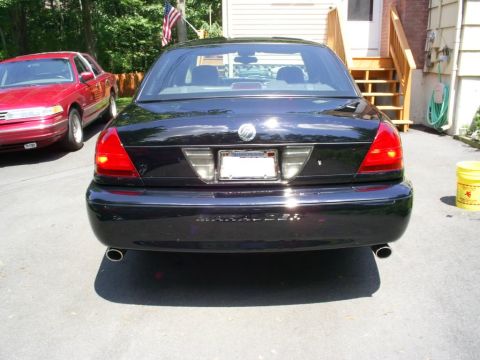 2003 Mercury Marauder - A black 2003 Mercury Marauder is parked in a driveway next to a red sedan.