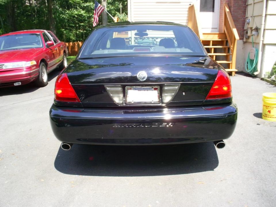 Black 2003 Mercury Marauder rear view with dual exhaust pipes and a license plate