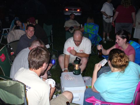 1991 Ford Probe - Group of friends playing cards outdoors at night, with a car visible in the distance.