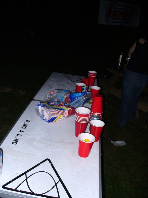 1991 Ford Probe - A table set up for a game of pong is covered in red cups and snack bags, suggesting a party atmosphere.