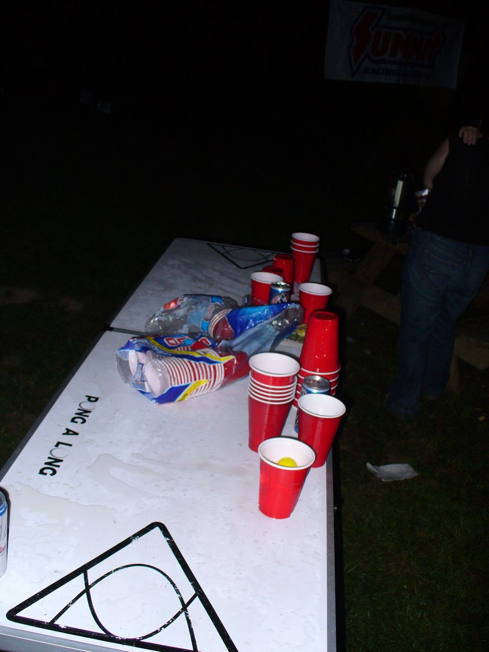 Pong a long table with red cups and chip bags