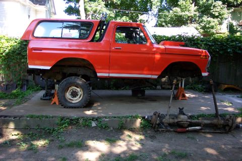 1978 Ford Bronco - This 1978 Ford Bronco is elevated on jack stands, awaiting mechanical work with its front axle disassembled.
