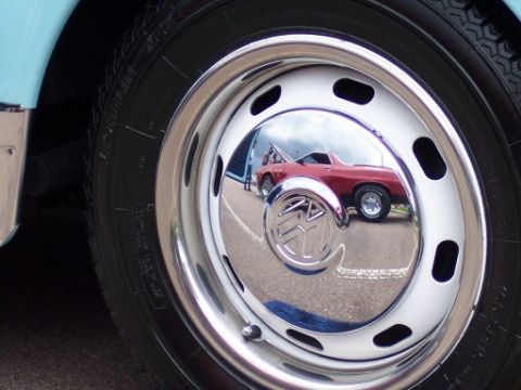 1972 Ford Ranchero - Reflection in the hubcap shows a red 1972 Ford Ranchero at a car show.